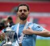 Bernardo Silva batte la mano sullo stemma del City